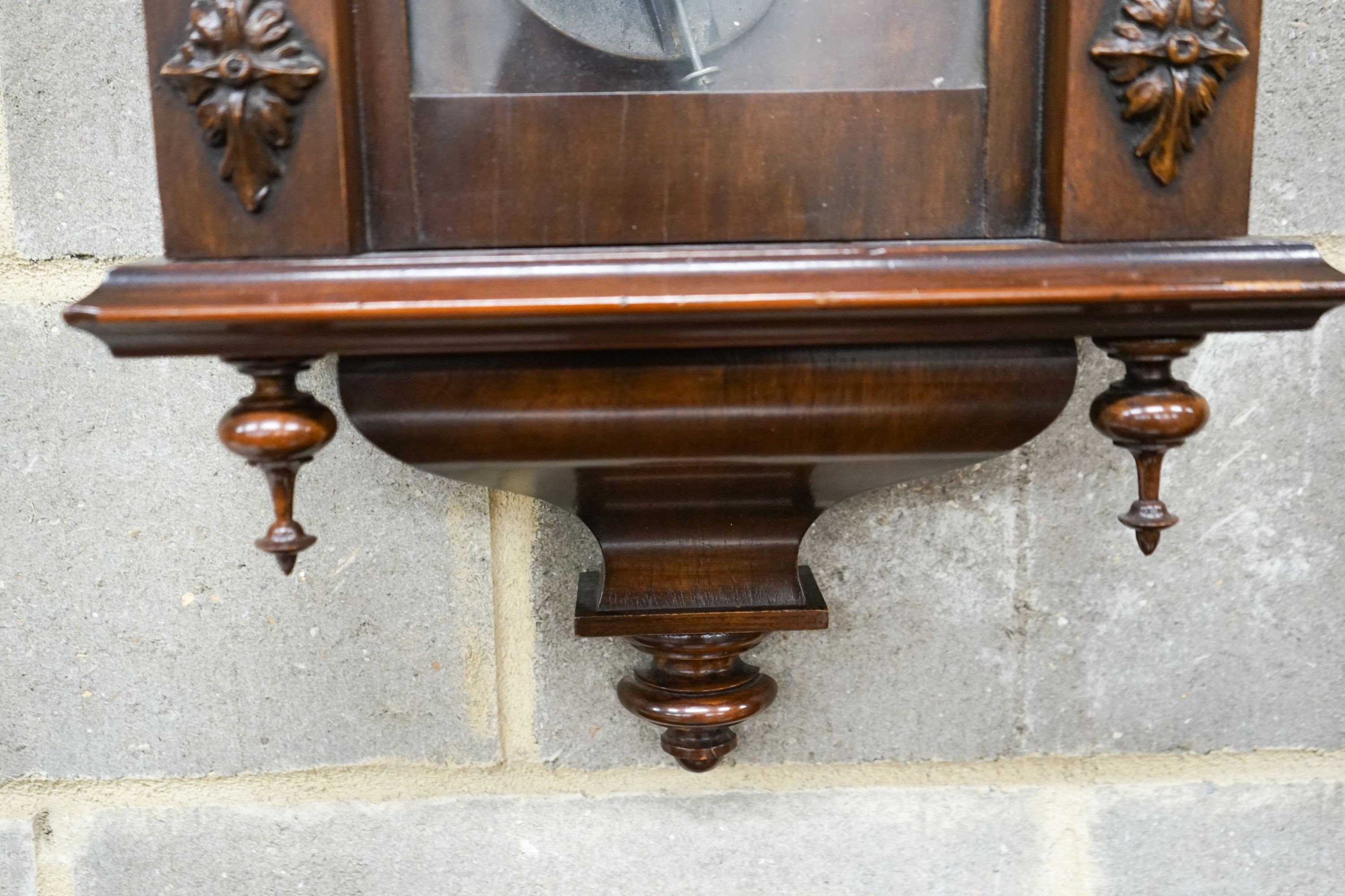 A Vienna style wall clock, having enamelled Roman dial and striking movement in glazed mahogany case, height 110cm